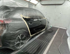 Car being resprayed black in a spray booth in Newquay