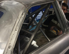 Sanding the frame of a BMW for a paint job in Newquay