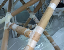 Internal framework of a BMW taped off for painting