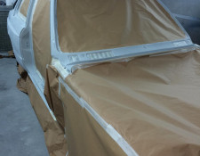 Parts of a BMW taped off for a paint job